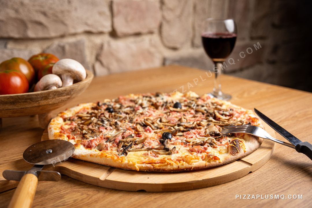 Regina pizza with a glass of red wine, in front of the dining room's stone wall